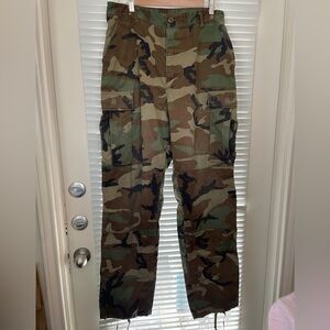 Military M-65 field pants in a woodland camouflage pattern